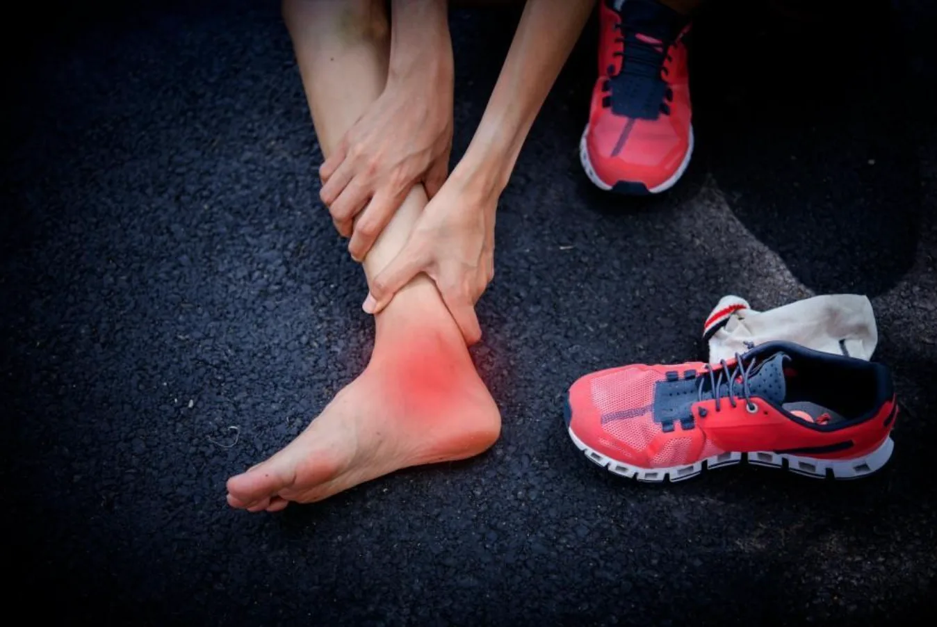 Ankle sprain treatment with red inflammation highlighted on ankle of runner. Understanding prevention and recovery strategies for common athletic injuries.