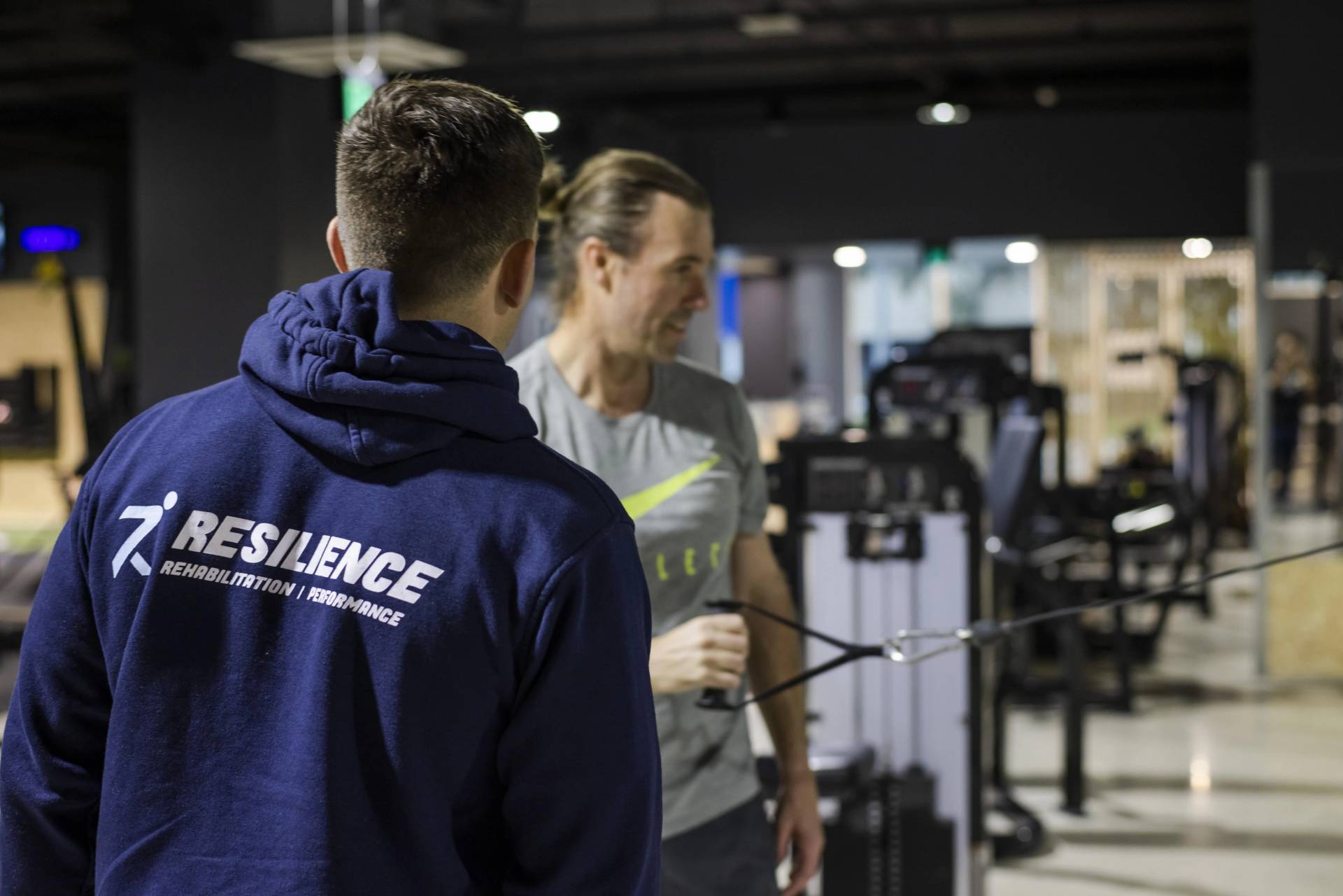 Michael Snape - RRP Exercise physiologist Hayden Egerton helping client train through back pain using RRP's Pain Codex rehab and performance approach (& physiotherapy)