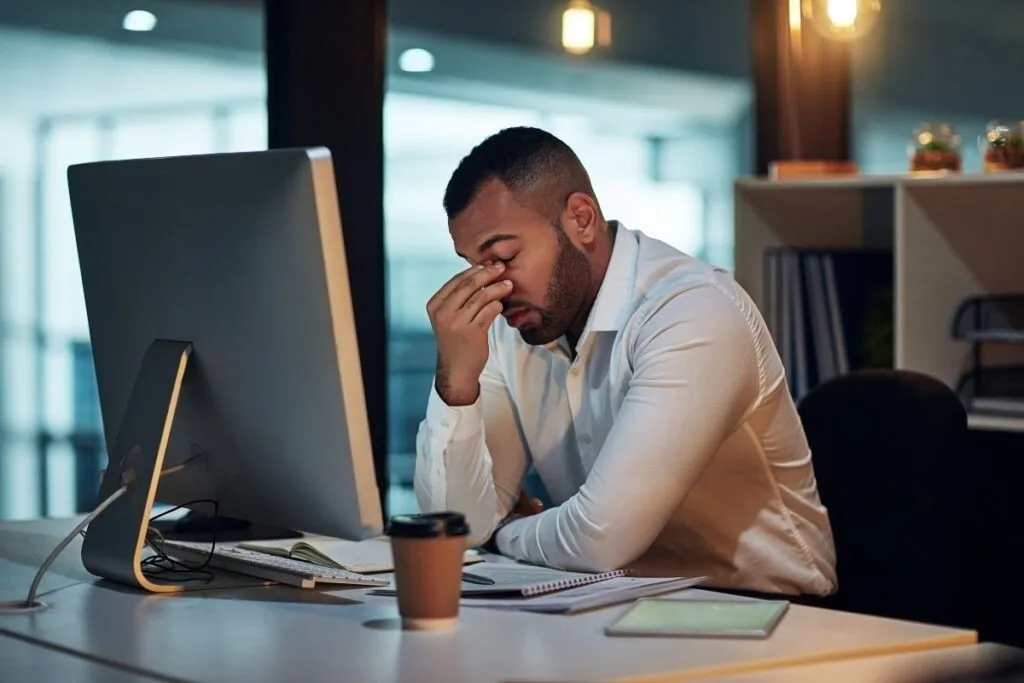 Man stressed at work - Resilience Rehab & Performance Man stressed at work. Science-based approaches to stress management in today's fast-paced environment.