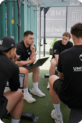 Group discussing in outdoor gym setting.