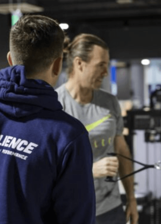Two people training in a gym.